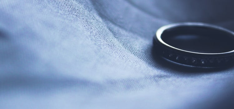 A silver ring on top of a blue fabric