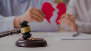 two people holding a broken heart in the background with gavel in front