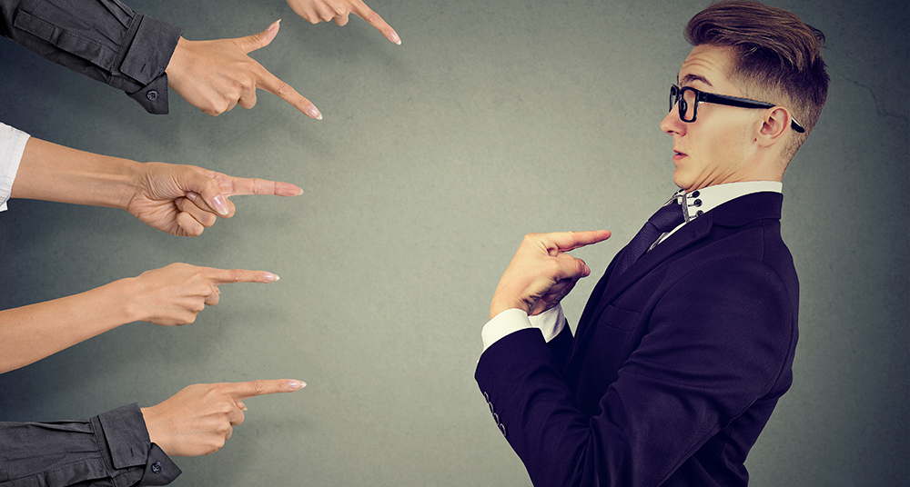 people pointing at a person with suit