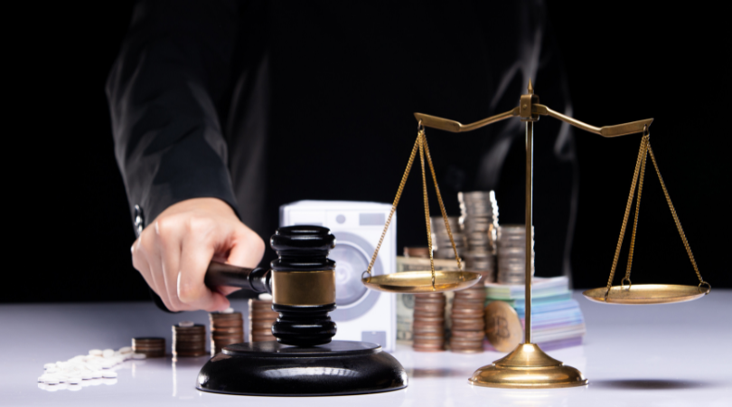 Person holding a gavel beside a scale with money and coin cleaner in the background