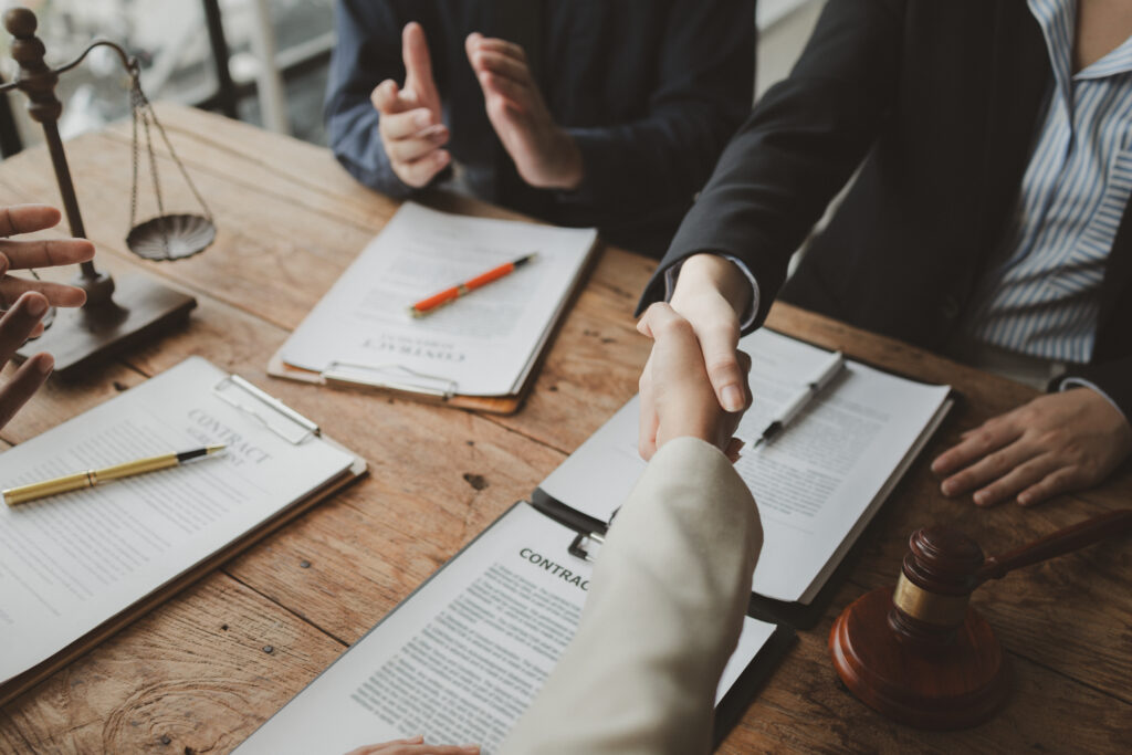 person with a pen signing